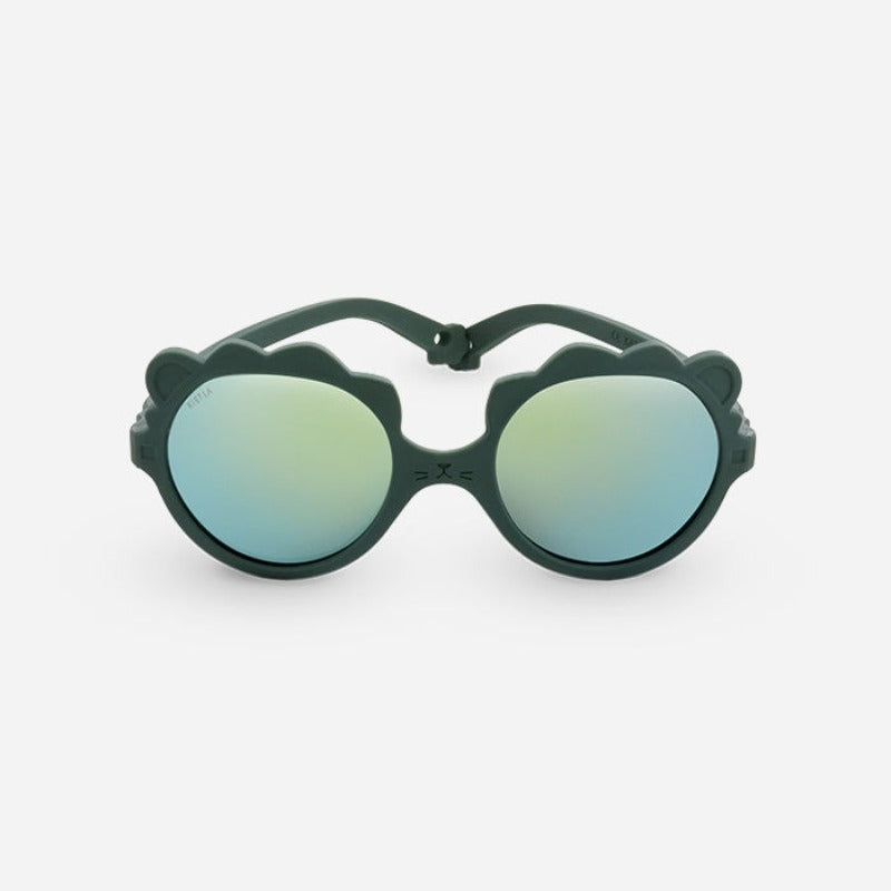 Lunettes solaires enfant de la marque Ki Et La, modèle lion coloris vert. incassables, douce, légère, haute protection, made in France, eco friendly, the Must to have pour bébé