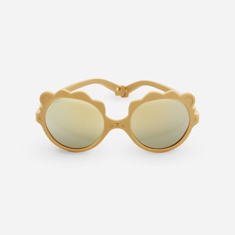 Lunettes solaires enfant de la marque Ki Et La, modèle lion coloris miel.incassables, douce, légère, haute protection, made in France, eco friendly, the Must to have pour bébé