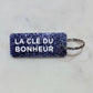 LA CLÉ DU BONHEUR Porte-clés à paillettes